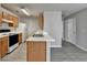 Well-lit kitchen featuring wood cabinets, white appliances, and double sink at 2892 Norfair Ne Loop, Lithonia, GA 30038