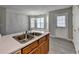 Kitchen area featuring a double sink, wood cabinets, and a window eating nook at 2892 Norfair Ne Loop, Lithonia, GA 30038