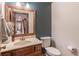 Stylish half bath features a wood vanity and framed mirror at 363 Wilcrest Dr, Lawrenceville, GA 30044