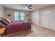 Comfortable bedroom features neutral walls, carpet and ceiling fan, complemented by natural light from the window at 363 Wilcrest Dr, Lawrenceville, GA 30044