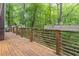Wooden deck overlooks lush, green wooded area with wooden railings at 363 Wilcrest Dr, Lawrenceville, GA 30044