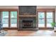 Modern fireplace featuring slate tile, a wood mantel, and view of the backyard at 363 Wilcrest Dr, Lawrenceville, GA 30044