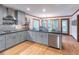 Bright kitchen features stainless steel appliances, gray cabinets, and island seating area at 363 Wilcrest Dr, Lawrenceville, GA 30044