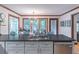 Kitchen island sink area boasts gray cabinets and granite countertops at 363 Wilcrest Dr, Lawrenceville, GA 30044