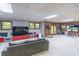 Open-concept living room with wood-paneled walls, recessed lights, entertainment center and a cozy gray sofa at 363 Wilcrest Dr, Lawrenceville, GA 30044