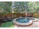 Private backyard featuring an in-ground spa, stone patio, and outdoor seating at 1125 Francis Ne St, Brookhaven, GA 30319