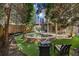 Backyard featuring an in-ground spa, outdoor furniture, spiral staircase, and a covered patio at 1125 Francis Ne St, Brookhaven, GA 30319