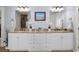 This bathroom features double sinks, granite countertops, framed mirrors, and white cabinets at 1125 Francis Ne St, Brookhaven, GA 30319