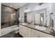 This bathroom features double sinks, granite countertops, and a tiled shower and tub at 1125 Francis Ne St, Brookhaven, GA 30319