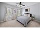 This bedroom features a ceiling fan, a full sized bed, and two large windows at 1125 Francis Ne St, Brookhaven, GA 30319
