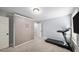 Bright bedroom featuring carpet, a built-in Murphy bed, and an exercise treadmill at 1125 Francis Ne St, Brookhaven, GA 30319