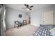 This bedroom offers two black and white plaid chairs, a ceiling fan, and neutral walls at 1125 Francis Ne St, Brookhaven, GA 30319