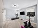 Well-lit exercise room including a Peloton bike, treadmill, and mounted TVs at 1125 Francis Ne St, Brookhaven, GA 30319
