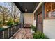 Inviting front porch with stone flooring, comfortable bench seating, and decorative plants at 1125 Francis Ne St, Brookhaven, GA 30319