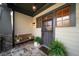 A welcoming front porch features a wooden bench, stone floor, and charming decorative accents at 1125 Francis Ne St, Brookhaven, GA 30319