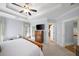 This spacious main bedroom features a ceiling fan, a tray ceiling, and neutral walls at 1125 Francis Ne St, Brookhaven, GA 30319