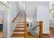 Traditional staircase boasts hardwood steps, contrasting risers, and elegant railings connecting different levels of the home at 1125 Francis Ne St, Brookhaven, GA 30319