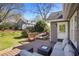 Backyard featuring a wood patio, a lounge set and dining set, lush grass, and mature trees at 235 Chicopee Ne Dr, Marietta, GA 30060