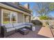 Backyard patio with a lounge set, lush green grass and mature trees at 235 Chicopee Ne Dr, Marietta, GA 30060