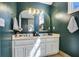 Elegant bathroom boasting double vanity, framed mirrors, and modern lighting fixtures at 235 Chicopee Ne Dr, Marietta, GA 30060