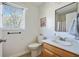 Bright bathroom featuring natural light, a white toilet, and a wood vanity at 235 Chicopee Ne Dr, Marietta, GA 30060