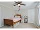 Cozy bedroom with a ceiling fan, wood bed frame, neutral walls, and carpeted floor at 235 Chicopee Ne Dr, Marietta, GA 30060