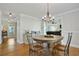 Bright dining room features hardwood floors, a modern chandelier, and a large dining table at 235 Chicopee Ne Dr, Marietta, GA 30060