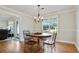 Elegant dining room features hardwood floors, a chandelier, and a large window at 235 Chicopee Ne Dr, Marietta, GA 30060