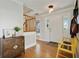 Inviting foyer featuring hardwood floors, a wooden staircase, and a charming yellow bench at 235 Chicopee Ne Dr, Marietta, GA 30060