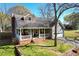 Charming home features a brick foundation, covered porch, and well-manicured lawn at 235 Chicopee Ne Dr, Marietta, GA 30060