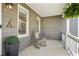 Inviting front porch with rocking chair, hanging plants, and charming decorative details at 235 Chicopee Ne Dr, Marietta, GA 30060