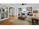 Open-concept living room and kitchen area with hardwood floors and bright lighting fixtures at 235 Chicopee Ne Dr, Marietta, GA 30060