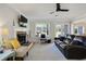 Cozy living room with fireplace, ceiling fan, and French doors leading to the backyard at 235 Chicopee Ne Dr, Marietta, GA 30060