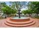 Picturesque town square featuring a beautiful tiered fountain surrounded by lush greenery and inviting benches at 235 Chicopee Ne Dr, Marietta, GA 30060