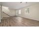 Bright living room with wood-look floors, large windows, and a staircase at 6354 Shannon Pkwy # 15D, Union City, GA 30291
