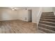 Inviting living room with staircase features wood-look floors and neutral paint at 6354 Shannon Pkwy # 15D, Union City, GA 30291