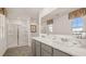 This bathroom features double sinks, a shower, and tile floors at 8595 Secretariat Dr, Lithonia, GA 30058
