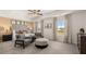 This main bedroom features a sitting area, tray ceiling, and neutral decor at 8595 Secretariat Dr, Lithonia, GA 30058