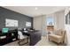 Functional office space with dark desk, shelves, and cozy chair offering an efficient and inviting workspace at 8595 Secretariat Dr, Lithonia, GA 30058