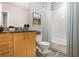 A cozy bathroom offers a tiled shower and tub, a tiled floor, and granite countertops at 943 Peachtree Ne St # 1003, Atlanta, GA 30309
