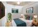 Inviting bedroom featuring a plush bed, stylish lamps, and tasteful artwork for a serene atmosphere at 943 Peachtree Ne St # 1003, Atlanta, GA 30309