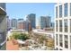 Beautiful city view from a condo balcony showcasing a skyline of modern buildings and trees at 943 Peachtree Ne St # 1003, Atlanta, GA 30309