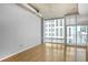 Bright and spacious living room features hardwood floors and large windows for ample natural light at 943 Peachtree Ne St # 1003, Atlanta, GA 30309