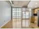 Bright, open living room features hardwood floors, a modern design, and expansive windows with city views at 943 Peachtree Ne St # 1003, Atlanta, GA 30309