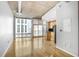 The living room is spacious and features large windows and stainless steel appliances in the adjacent kitchen at 943 Peachtree Ne St # 1003, Atlanta, GA 30309