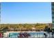 Inviting swimming pool with clear blue water, lounge chairs, and a scenic tree-lined view at 943 Peachtree Ne St # 1003, Atlanta, GA 30309