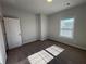 Bright bedroom featuring neutral walls, carpet floors, and natural light from a window at 122 Stonehouse Dr, Cumming, GA 30040