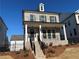 Attractive brick home with a charming covered porch and wrought iron railings at 122 Stonehouse Dr, Cumming, GA 30040
