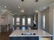 Open concept living room and kitchen with modern island and lighting at 122 Stonehouse Dr, Cumming, GA 30040