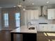 Bright kitchen with white cabinets, modern appliances, and a large island at 122 Stonehouse Dr, Cumming, GA 30040